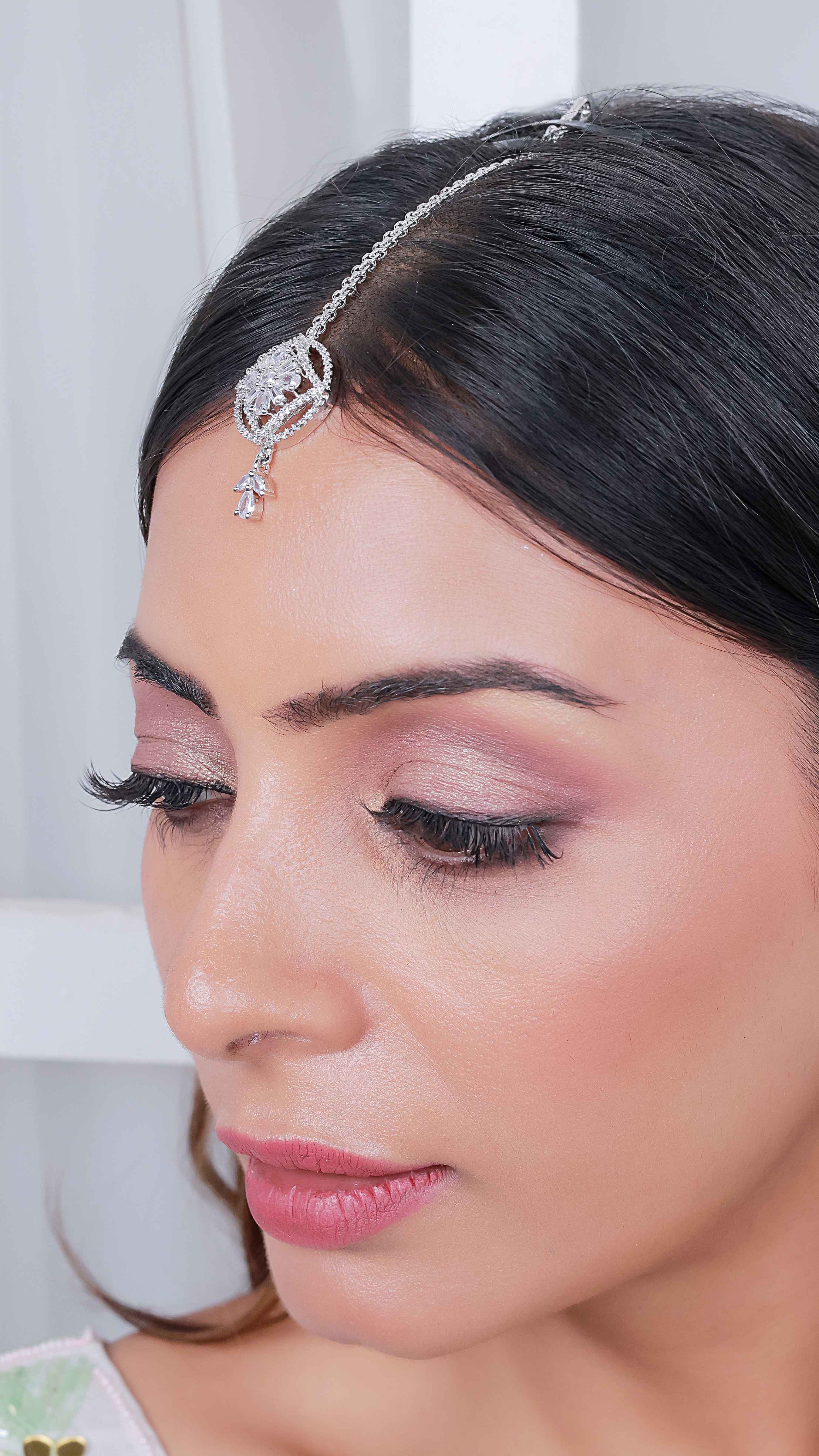 Model wearing silver plated American diamond maangtika – bridal and festive forehead jewelry