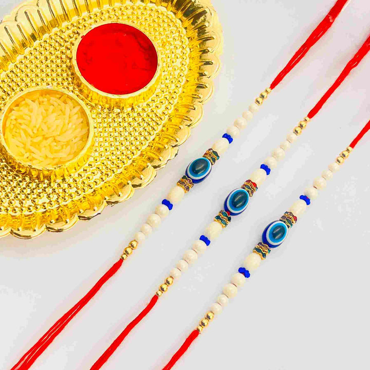 3 Pcs Red Thread Evil Eye Rakhi Set with White Beads & Roli Chawal