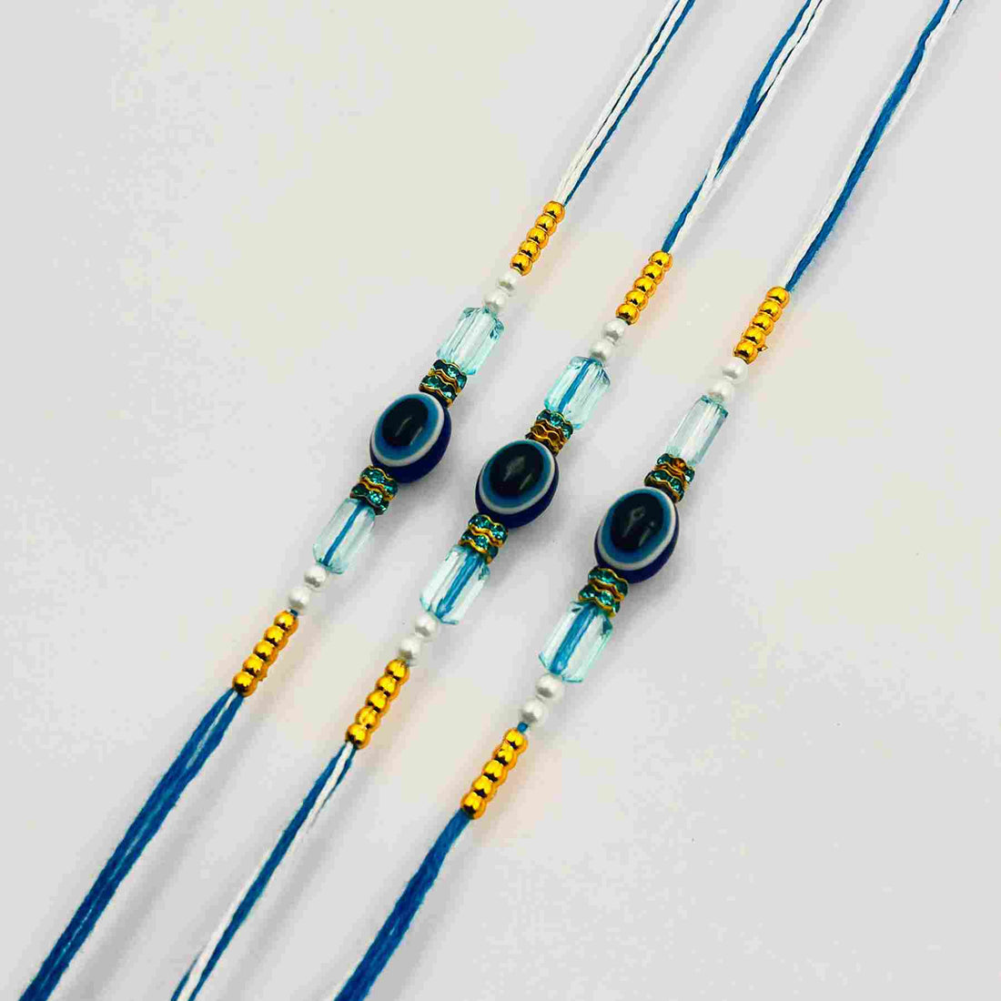3 Pcs Royal Blue Evil Eye Rakhi Set with Golden Beads & Tikka
