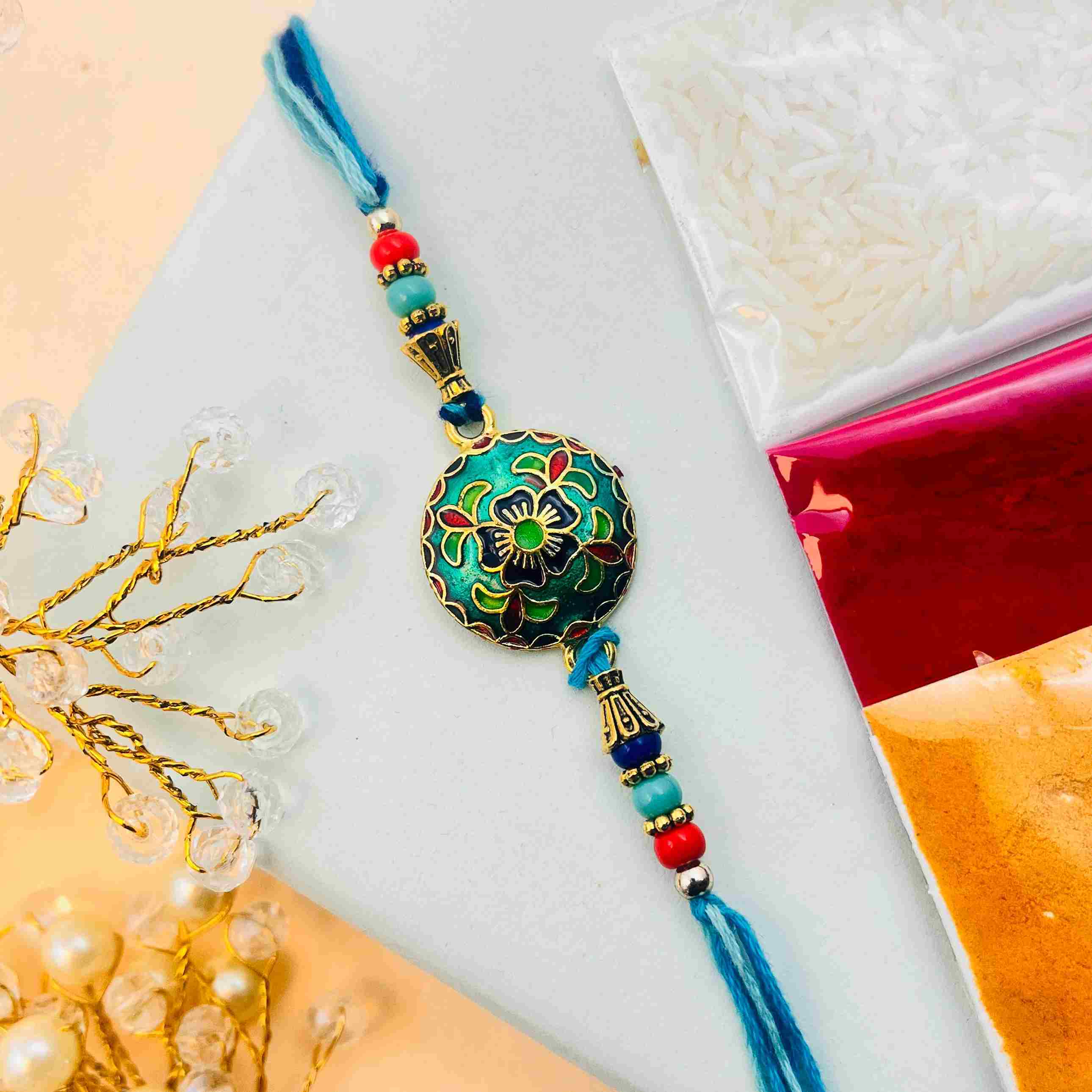 Metal Meenakari Rakhi with Royal Blue Thread