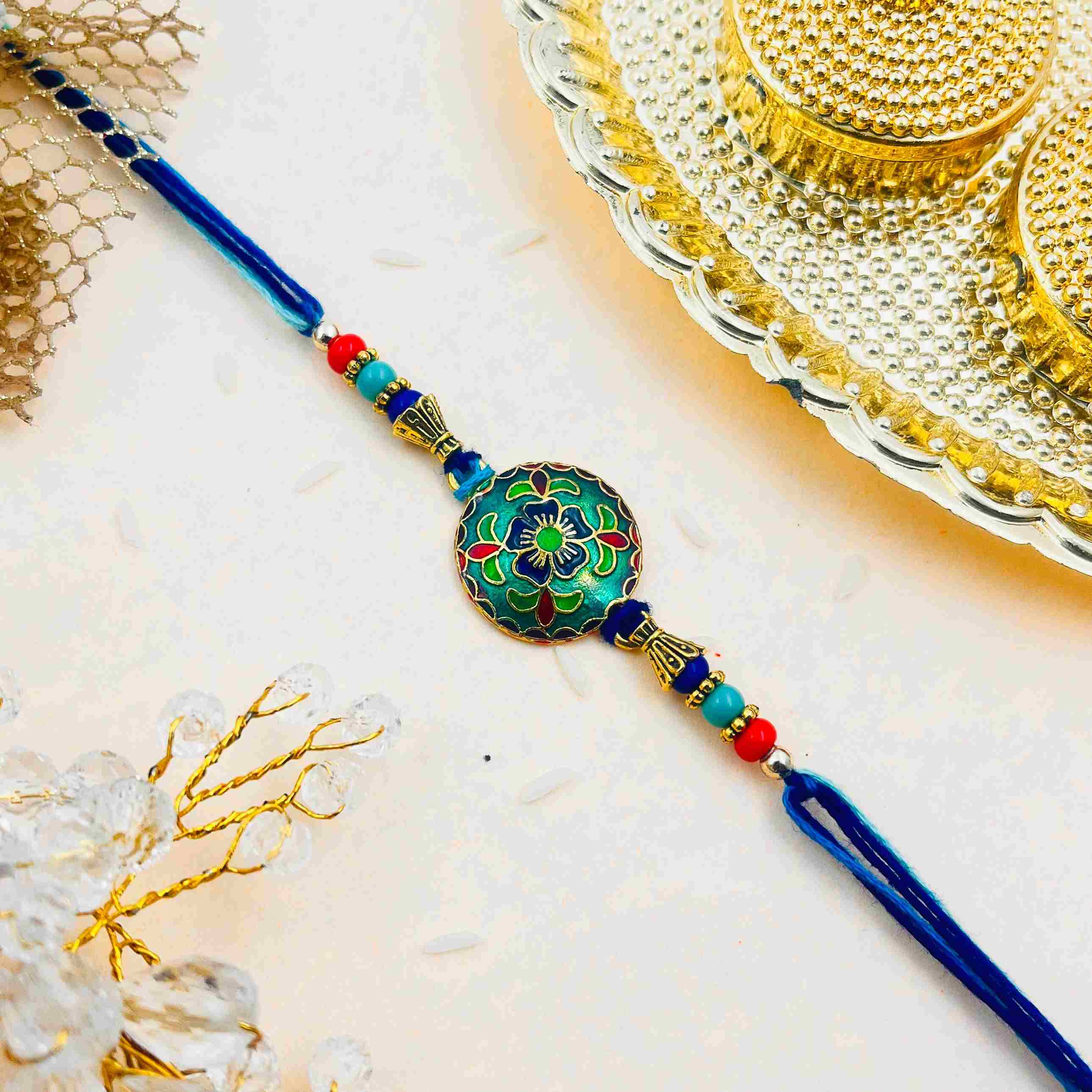Metal Meenakari Rakhi with Royal Blue Thread