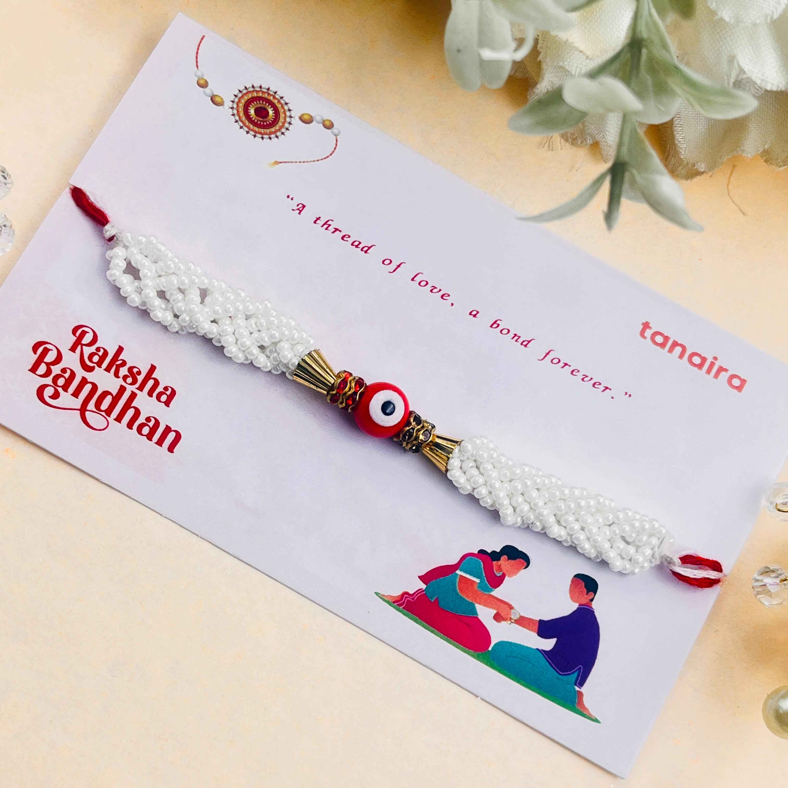 Red Evil Eye Rakhi with White Pearl Beaded Braids