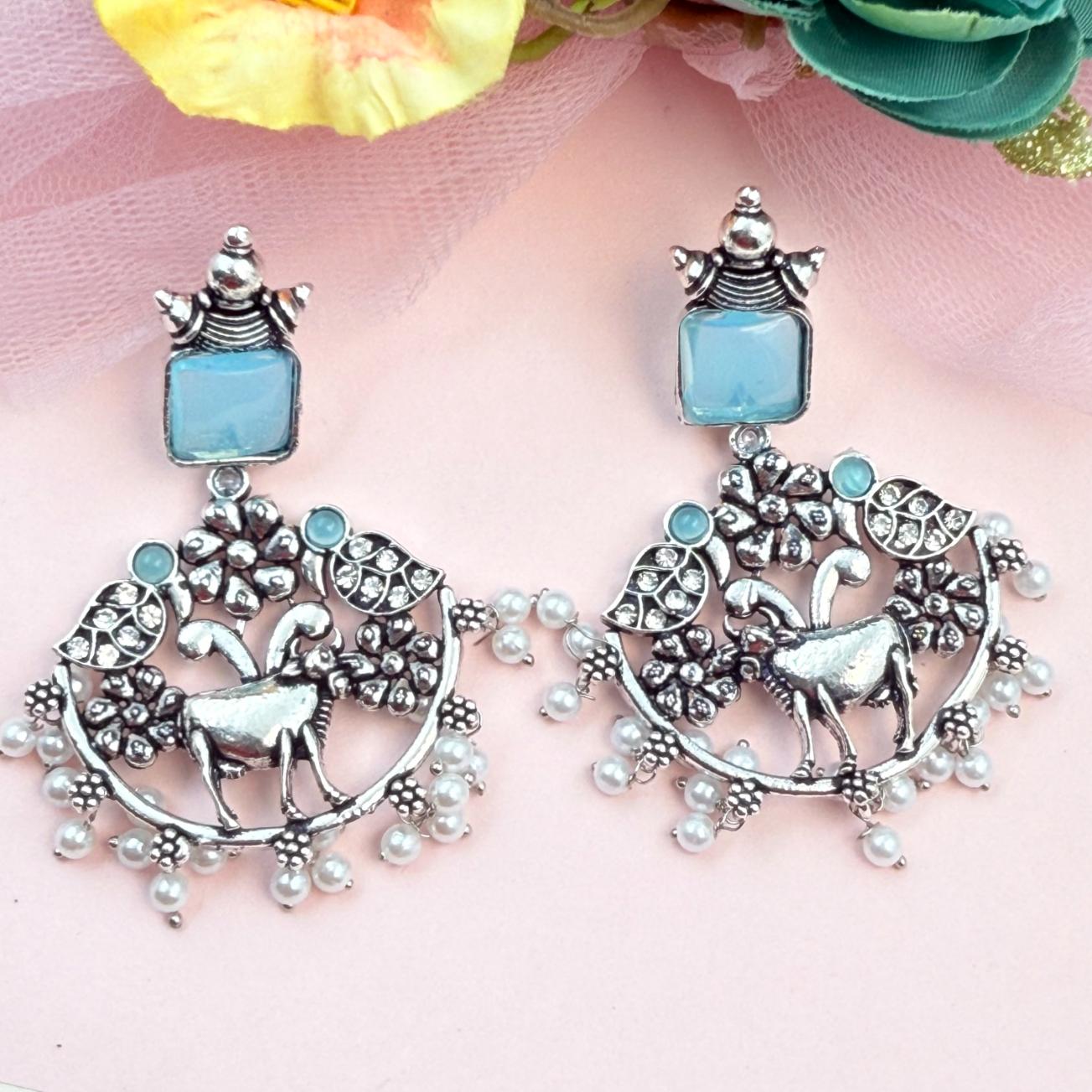 Handcrafted oxidised silver statement earrings with deer design pearls and blue stone perfect for festive ethnic styling