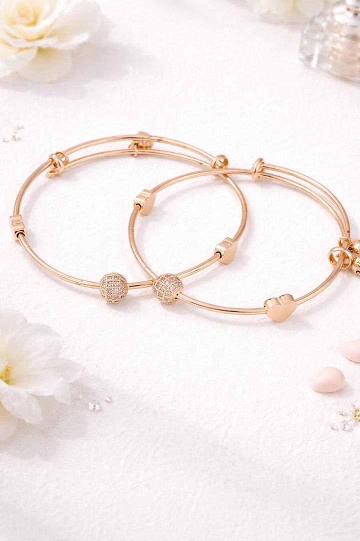 Minimal rose gold bangle bracelet set with heart charm and crystal ball design