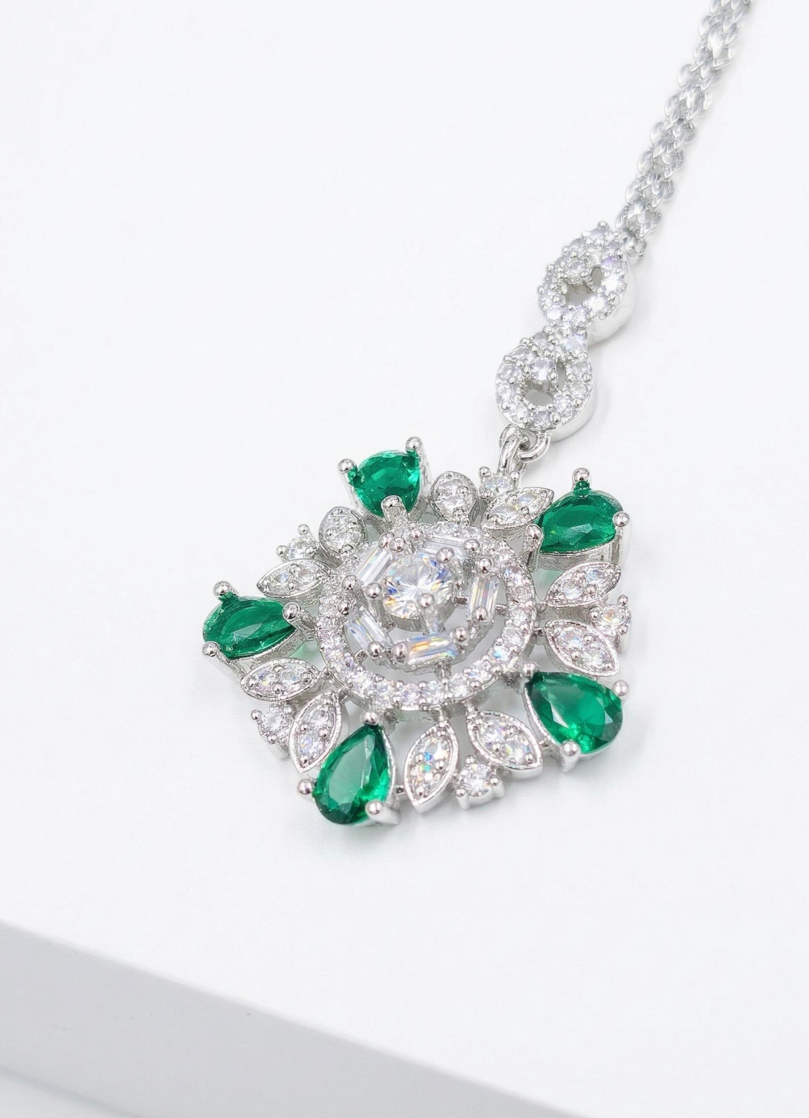 silver floral ad maangtika with green stones indian traditional hair jewellery