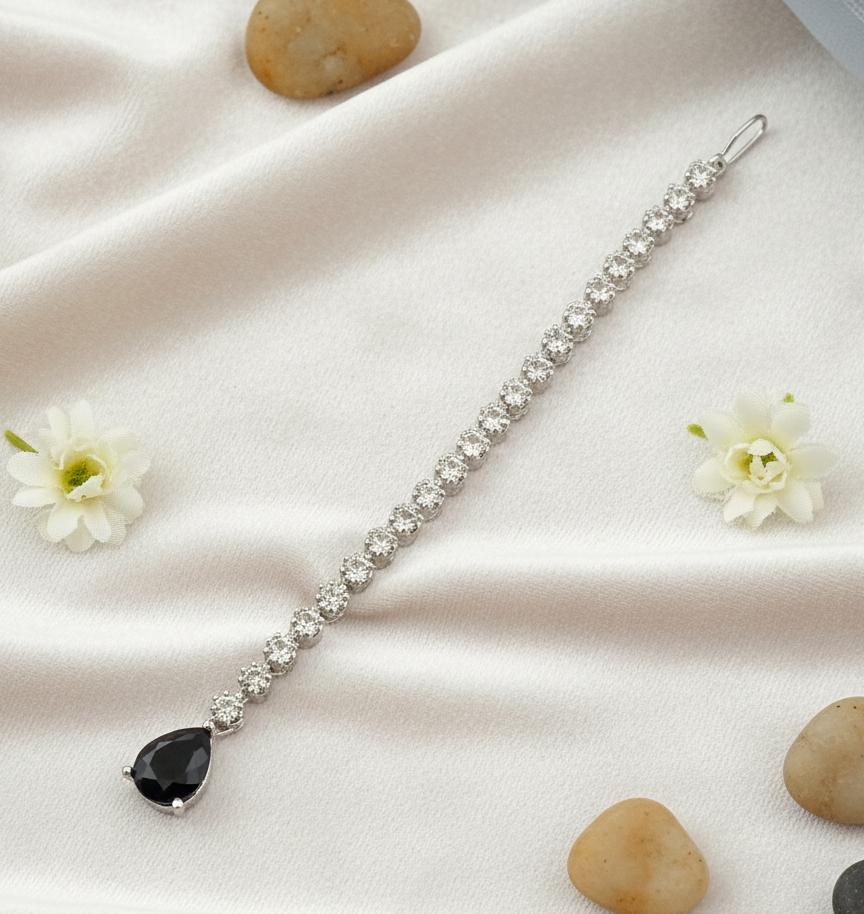 silver finish maang tikka with sparkling white stones and black pear drop pendant for women